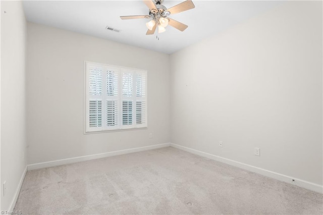 unfurnished room with baseboards, carpet floors, visible vents, and a ceiling fan