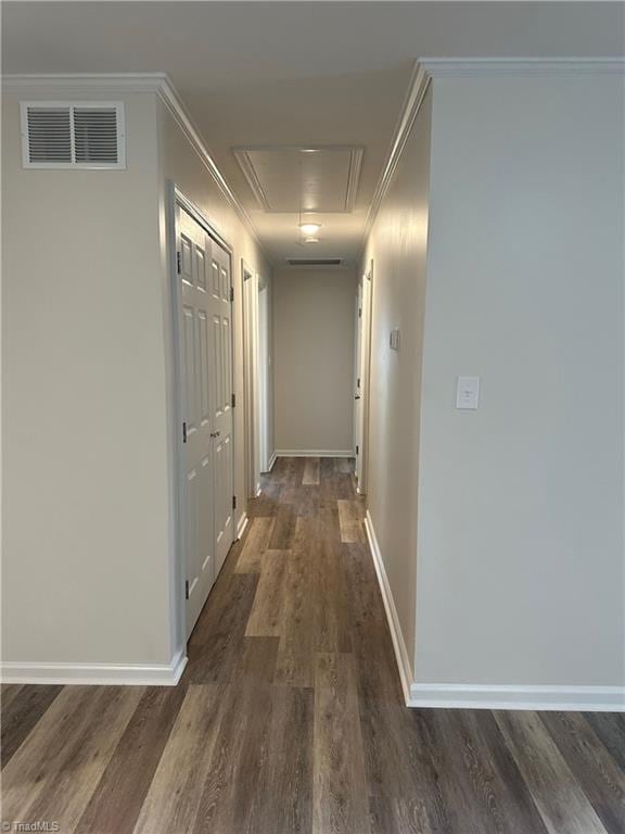 hallway featuring ornamental molding and dark hardwood / wood-style flooring