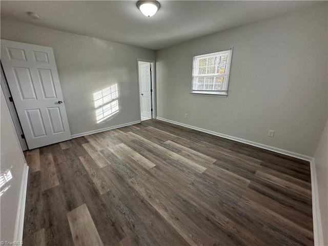 unfurnished bedroom featuring dark wood-type flooring