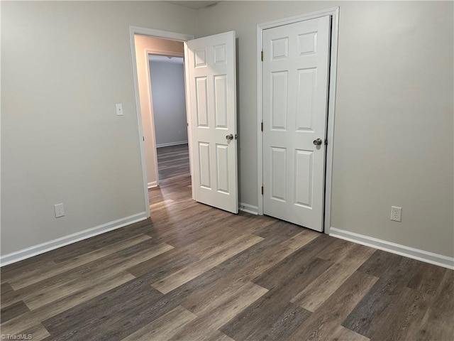 unfurnished room with dark hardwood / wood-style floors