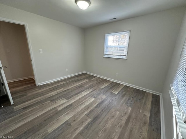 empty room featuring dark hardwood / wood-style floors