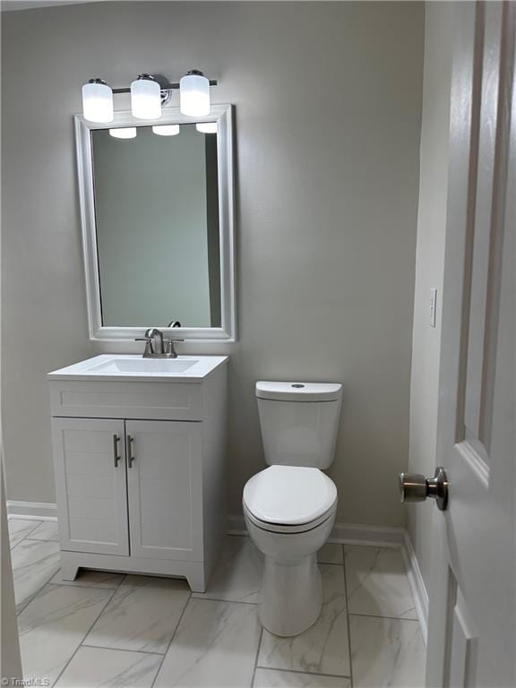 bathroom with toilet and vanity