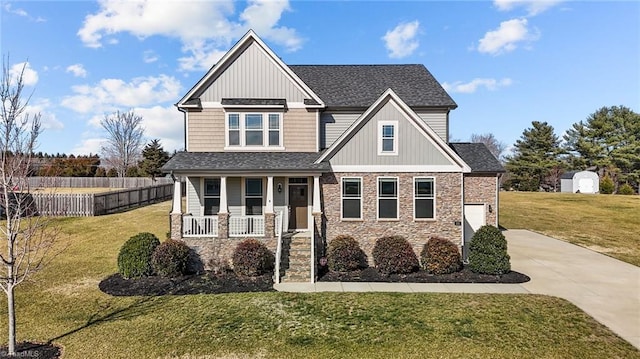 craftsman-style home featuring a front yard and covered porch