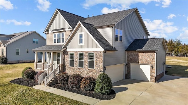 view of front facade featuring a garage, a front lawn, and a porch