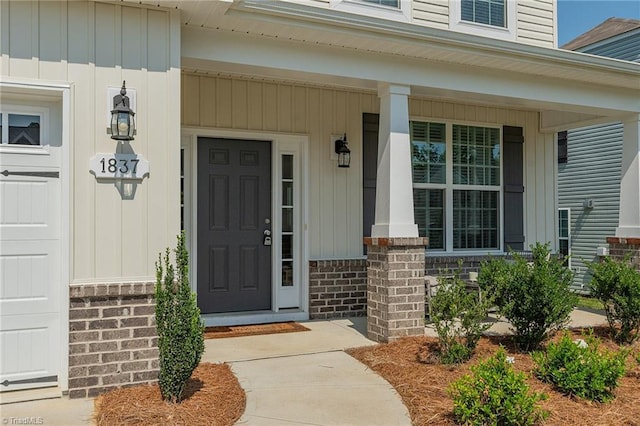 1837 Deveron Ct, Kernersville, NC 27284 - view of exterior entry featuring covered porch, board and batten siding, and brick siding