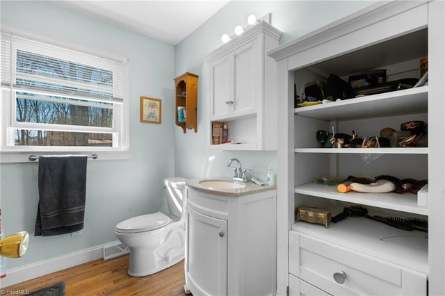 bathroom featuring hardwood / wood-style flooring, vanity, and toilet