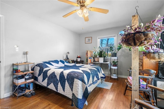 bedroom featuring hardwood / wood-style floors and ceiling fan