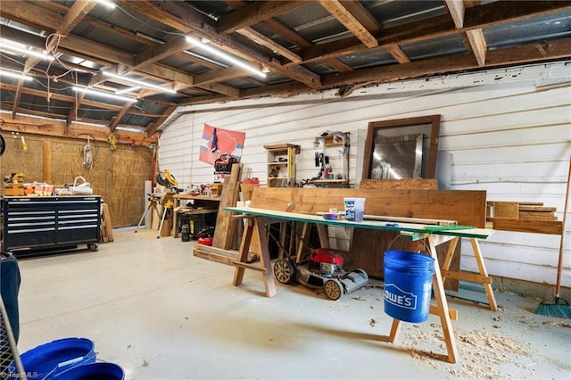 miscellaneous room with a workshop area and concrete floors