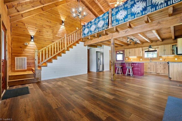 unfurnished living room featuring wood ceiling, stairway, beam ceiling, a chandelier, and dark wood-type flooring