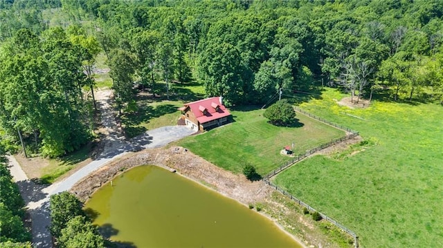 view of property location featuring a forest and a large body of water