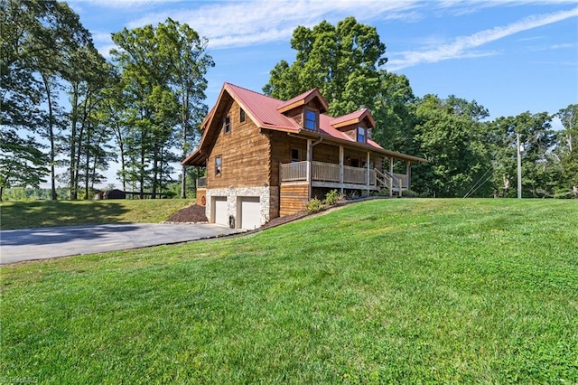 view of side of property featuring driveway, an attached garage, and a lawn