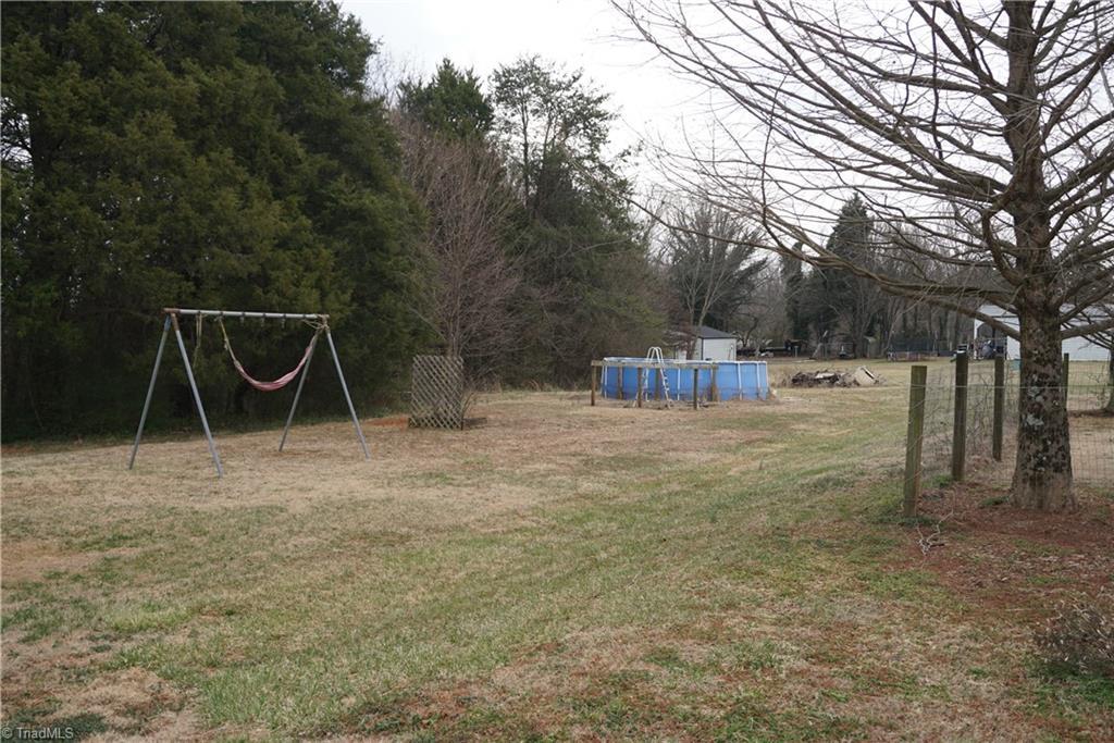 view of yard with a playground and an outdoor pool