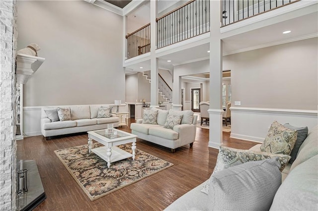 128 Provence Ct, King, NC 27021 - living room featuring decorative columns, a towering ceiling, stairway, wood finished floors, and ornamental molding
