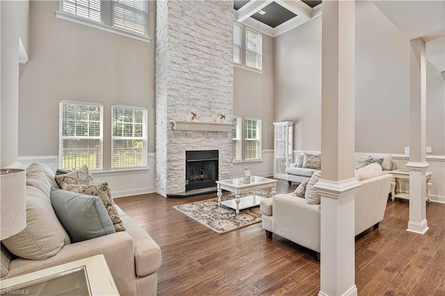 128 Provence Ct, King, NC 27021 - living room with a high ceiling, wood finished floors, ornate columns, and a stone fireplace