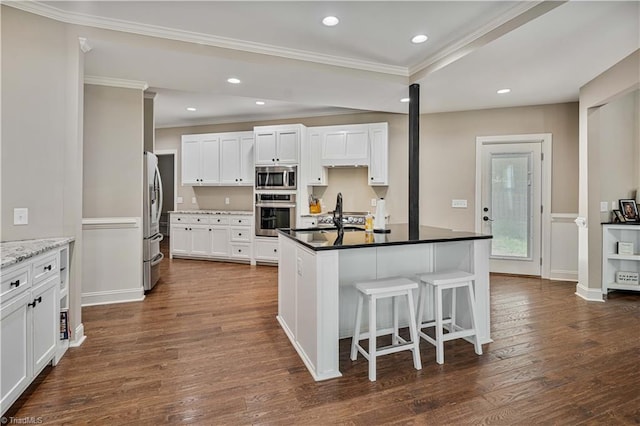 128 Provence Ct, King, NC 27021 - kitchen featuring stainless steel appliances, ornamental molding, dark wood-style floors, a breakfast bar, and white cabinets