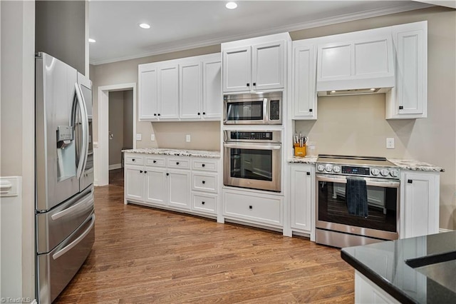 128 Provence Ct, King, NC 27021 - kitchen featuring stainless steel appliances, ornamental molding, white cabinets, wood finished floors, and light stone countertops