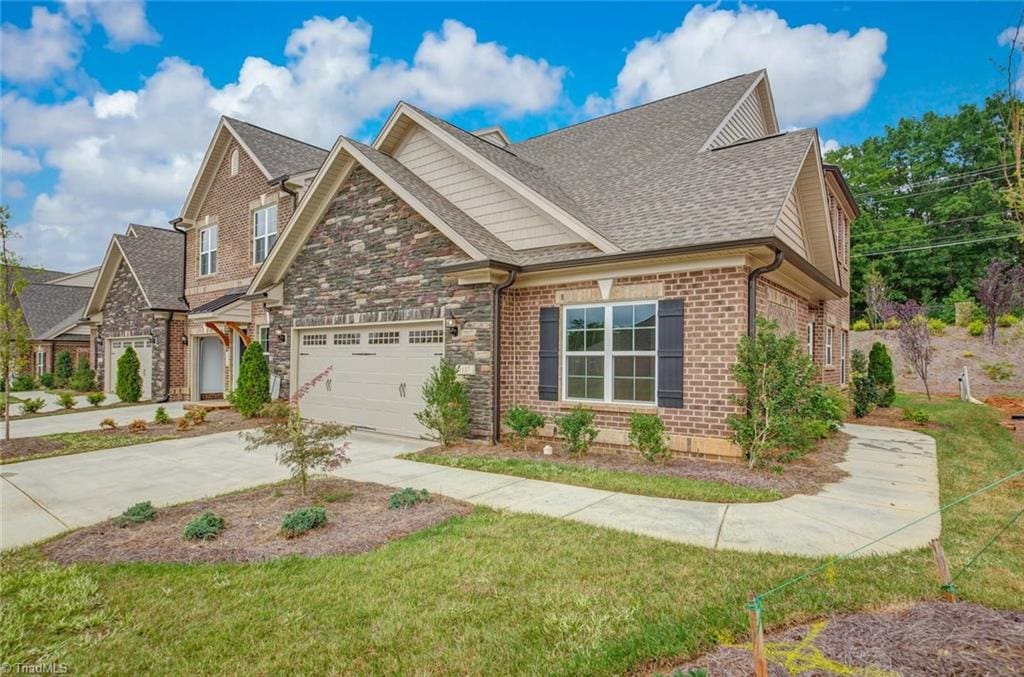 craftsman-style home featuring a front yard and a garage