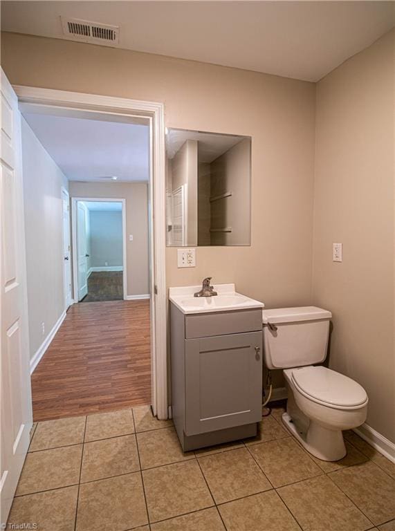 2370 W Clemmonsville Rd, Winston-Salem, NC 27127 - bathroom with tile patterned flooring, toilet, vanity, and baseboards