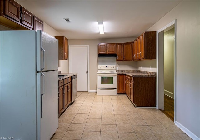 2370 W Clemmonsville Rd, Winston-Salem, NC 27127 - kitchen featuring white appliances, baseboards, light tile patterned flooring, and under cabinet range hood