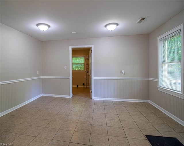 2370 W Clemmonsville Rd, Winston-Salem, NC 27127 - unfurnished room with wainscoting, light tile patterned flooring, and baseboards