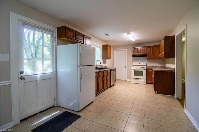 2370 W Clemmonsville Rd, Winston-Salem, NC 27127 - kitchen with white appliances, a sink, light tile patterned flooring, brown cabinets, and light countertops