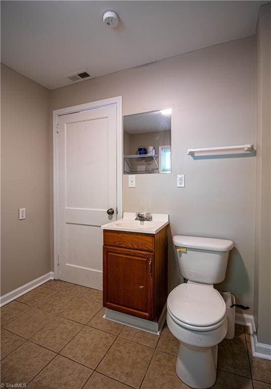 2370 W Clemmonsville Rd, Winston-Salem, NC 27127 - bathroom with tile patterned flooring, vanity, baseboards, and toilet