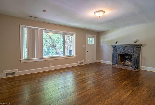2370 W Clemmonsville Rd, Winston-Salem, NC 27127 - unfurnished living room with dark wood-style floors, a fireplace with flush hearth, and baseboards