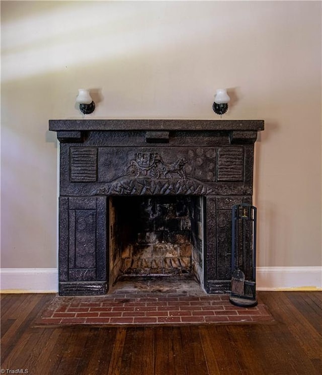 2370 W Clemmonsville Rd, Winston-Salem, NC 27127 - detailed view of a fireplace with flush hearth, baseboards, and wood finished floors