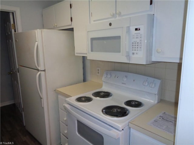 kitchen with white appliances, dark wood-type flooring, tasteful backsplash, and white cabinetry