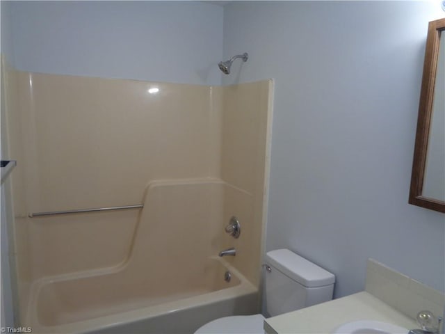 full bathroom featuring toilet, vanity, and tub / shower combination