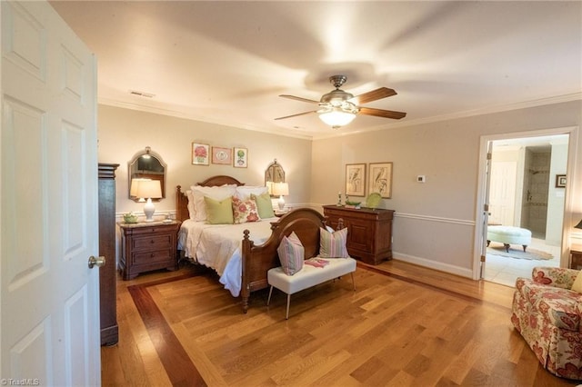 bedroom featuring a ceiling fan, visible vents, baseboards, light wood-style floors, and crown molding