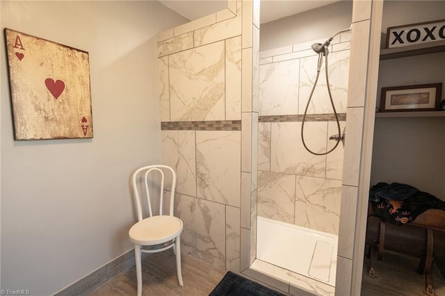 bathroom featuring wood finished floors and tiled shower