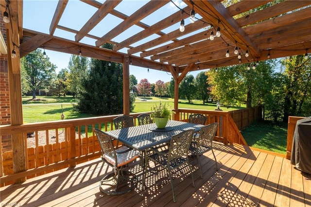 deck with outdoor dining area, a lawn, and a pergola