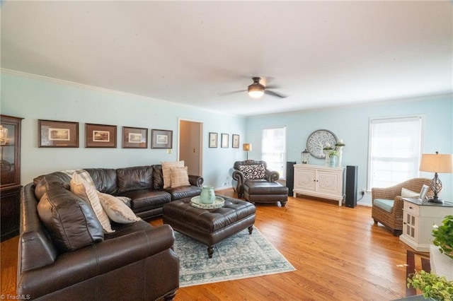 living area with light wood finished floors and ceiling fan