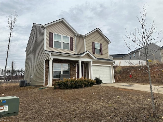 view of front of property featuring a garage and central AC unit