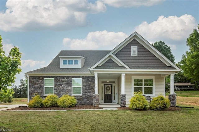 1348 Motsinger Rd, Winston-Salem, NC 27107 - craftsman-style house with roof with shingles, a porch, a front lawn, and stone siding