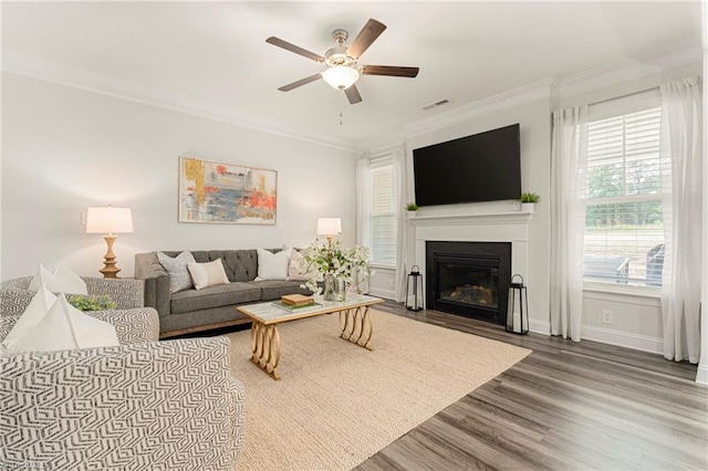 1348 Motsinger Rd, Winston-Salem, NC 27107 - living room with a ceiling fan, visible vents, crown molding, a fireplace with flush hearth, and wood finished floors