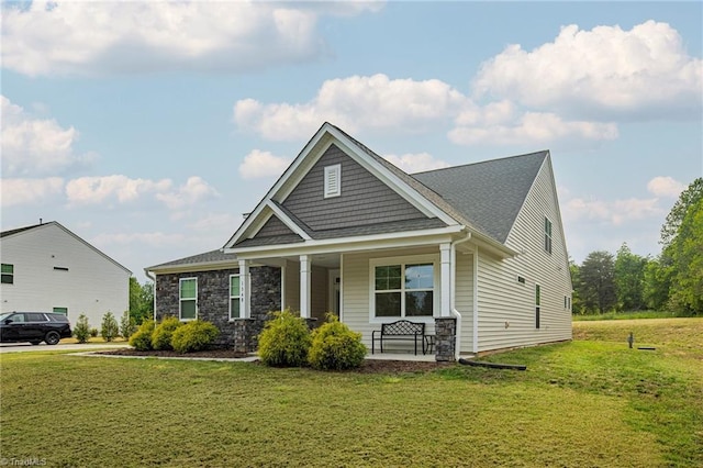 1348 Motsinger Rd, Winston-Salem, NC 27107 - craftsman house featuring a front lawn, covered porch, and stone siding
