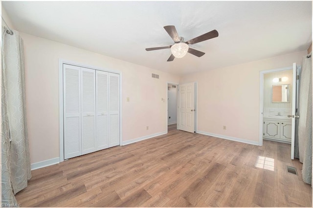 3306 Midkiff Rd, Winston-Salem, NC 27106 - unfurnished bedroom with light wood-style floors, baseboards, a closet, ceiling fan, and ensuite bathroom
