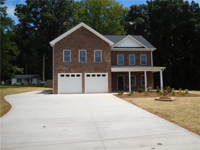 view of front facade with a front yard and a garage