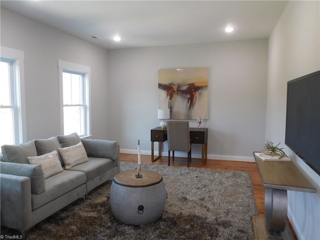 living area featuring recessed lighting, wood finished floors, and baseboards