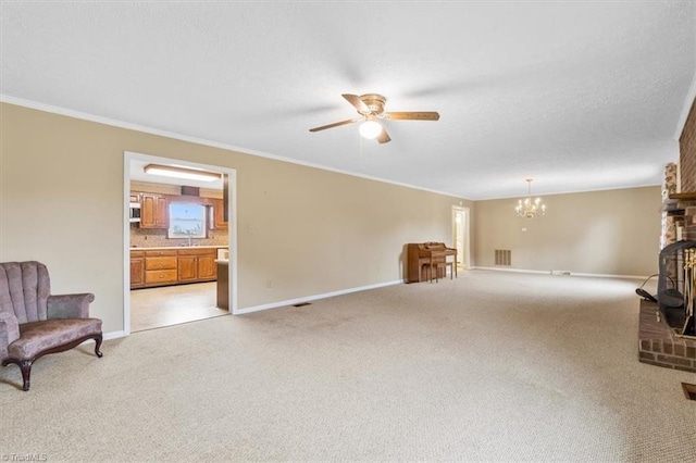 carpeted living room featuring a wood stove, ceiling fan with notable chandelier, and ornamental molding