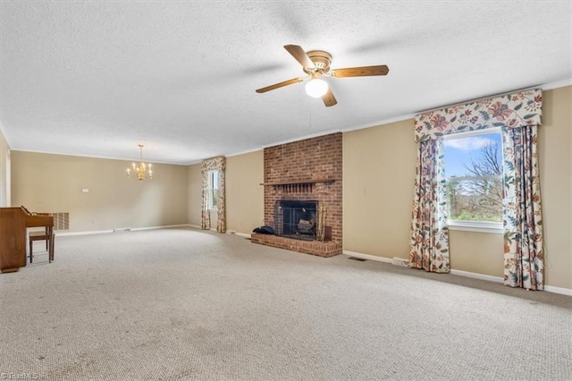 unfurnished living room with a textured ceiling, a fireplace, carpet, ceiling fan with notable chandelier, and ornamental molding