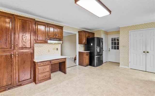 kitchen featuring stainless steel fridge with ice dispenser and crown molding