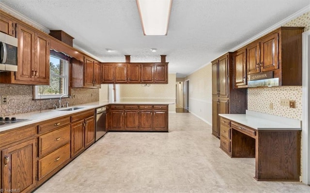 kitchen with stainless steel appliances, tasteful backsplash, ornamental molding, and sink