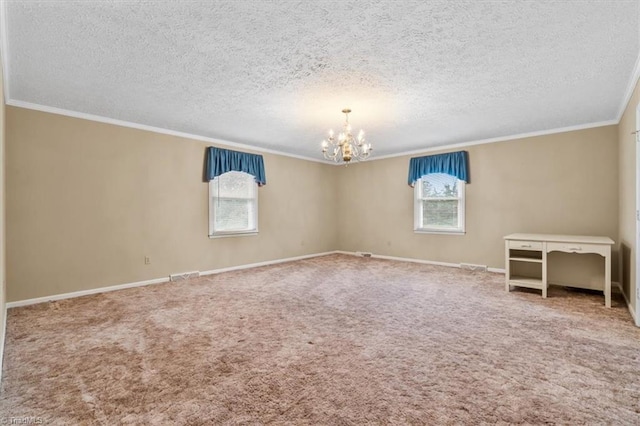 spare room with carpet, a textured ceiling, and an inviting chandelier