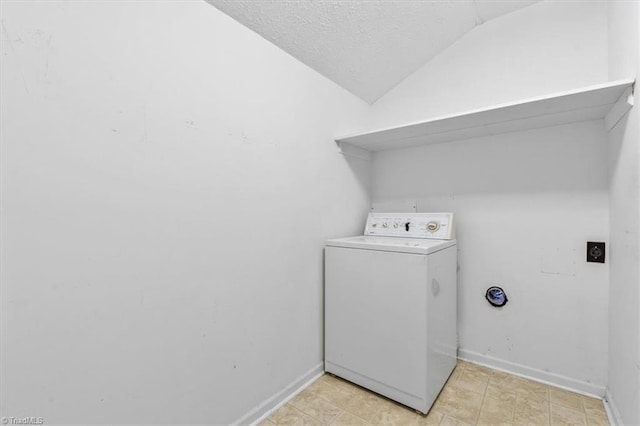 clothes washing area featuring a textured ceiling and washer / clothes dryer