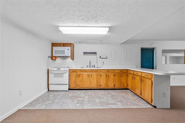 kitchen featuring kitchen peninsula, sink, light colored carpet, and white appliances