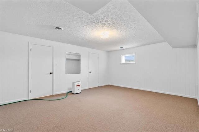 interior space featuring carpet floors and a textured ceiling