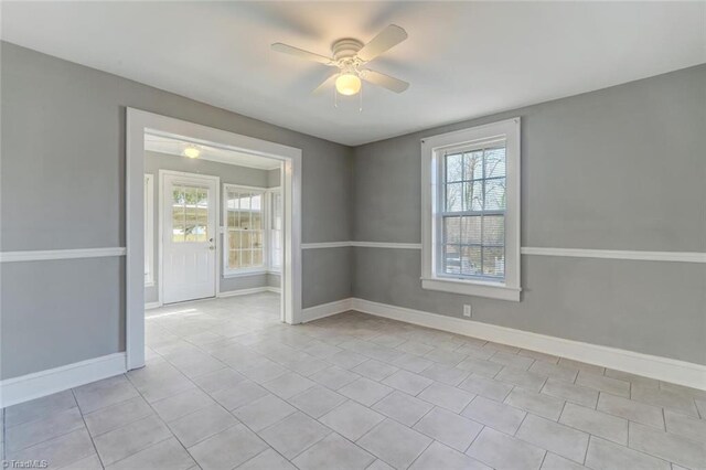 tiled empty room with ceiling fan